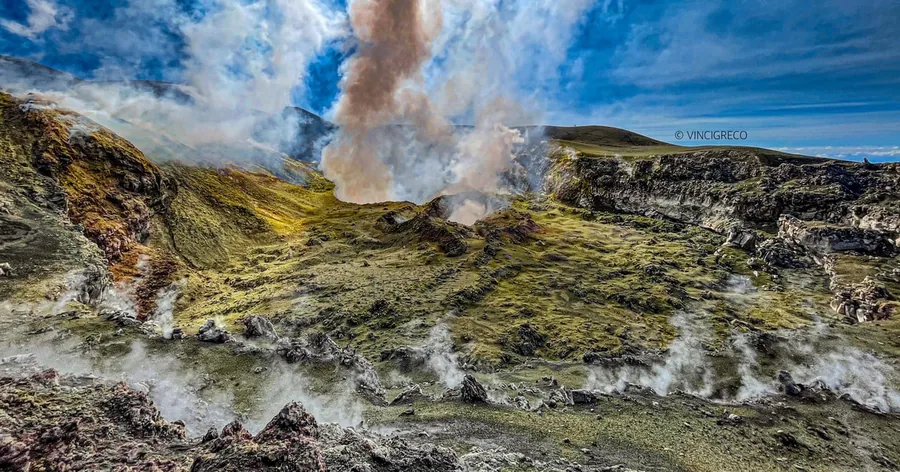 Steaming vents and yellow and green mineral crusts on a summit crater of Etna